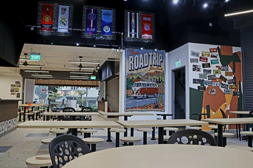 Vibrant cafeteria with sports banners and road trip tapestry