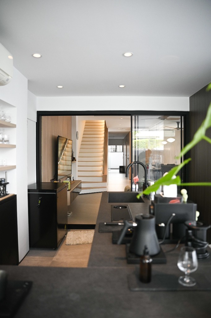 View looking through residential hallway toward stairs